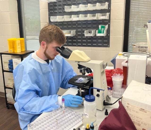 Medical Laboratory Science Student and Microscope