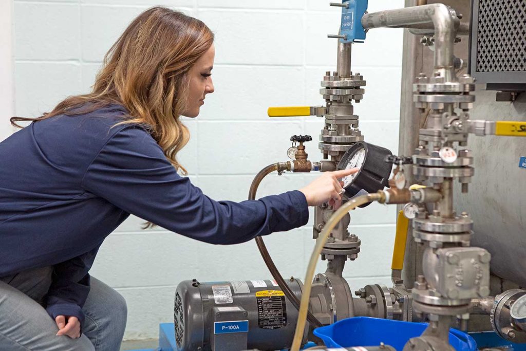 McNeese chemical engineering student watching pressure gauge.