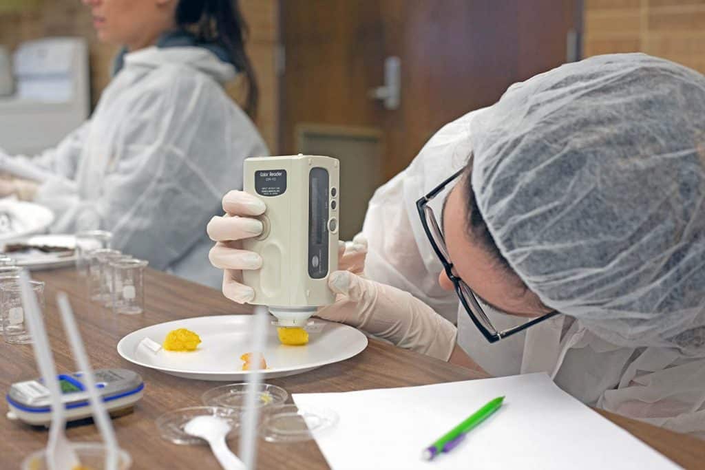 McNeese student portioning food samples