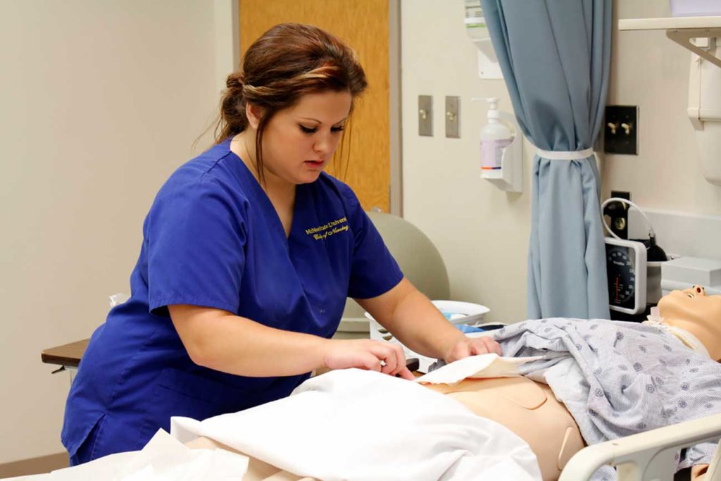 McNeese nursing student practices on mannequin while pursing BSN degree