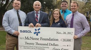 Gary Keers, Megan Landry, and Matt LeBlanc present a check to Dr. Daryl Burckel of McNeese