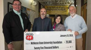 Dr. Nikos Kiritsis and Richard H. Reid of McNeese stand with Richard G Harbison and Megan Hartman of Phillips 66 for the check presentation.