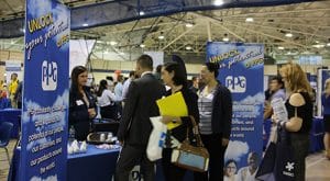 Students and alumni visit with a Career Fair sponsor.