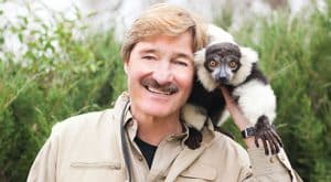 Peter Gros with a small animal on his shoulder.