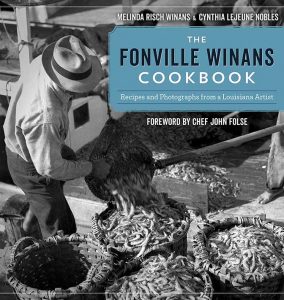 Man empties a sack of shrimp on The Fonville Winans Cookbook cover