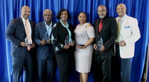 BAC recipients stand with their awards