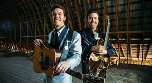 The Malpass Brothers stand with guitars