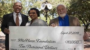 Barbara and DePorres Cormier present a check to Richard Reid of McNeese