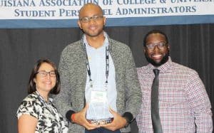 Ryan Preatto, C.A.R.E. program coordinator, receives the program of the year award from LACUSPA representatives. 