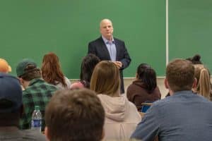 B.J. Hebert addresses the classroom full of students