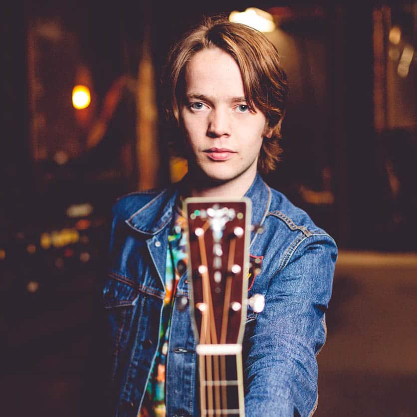 Billy Strings with his instrument