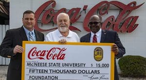 Blaine Royer, on-premise manager for Lake Charles Coca-Cola, Richard H. Reid, vice president for university advancement and executive vice president of the foundation, and Ken Francis, sales center manager for Lake Charles Coca-Cola.