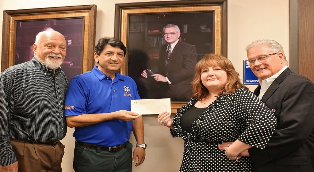 Richard H. Reid, vice president for university advancement and executive vice president of the foundation, Dr. Matthew Aghili, associate dean of the McNeese College of Engineering and Computer Science, and Karen and Ken Chamberlain. Karen’s grandfather is the late Dr. Thomas S. Leary, McNeese’s third president whose portrait is in the background.