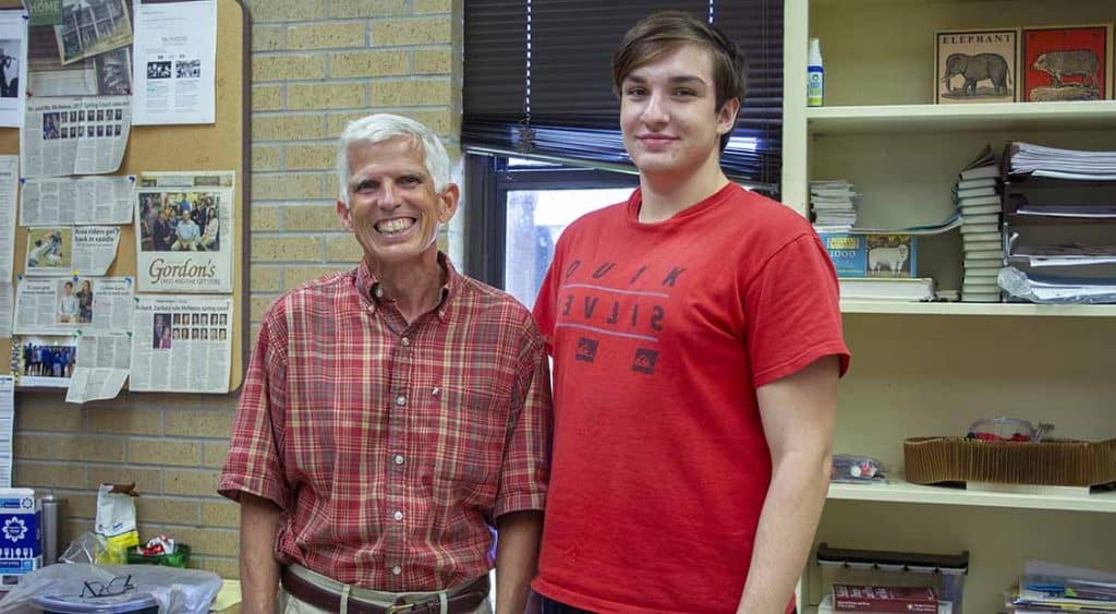 Dr. Scott Goins, director of Honors College, and Richard Robicheaux, a second year Honors College student stand together in the Honors College work room at McNeese State University. Richard is the fourth Robicheaux sibling to be accepted into the program.