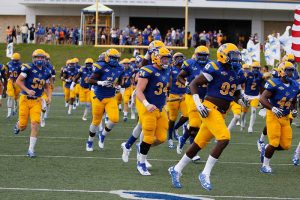 The McNeese football team takes the field