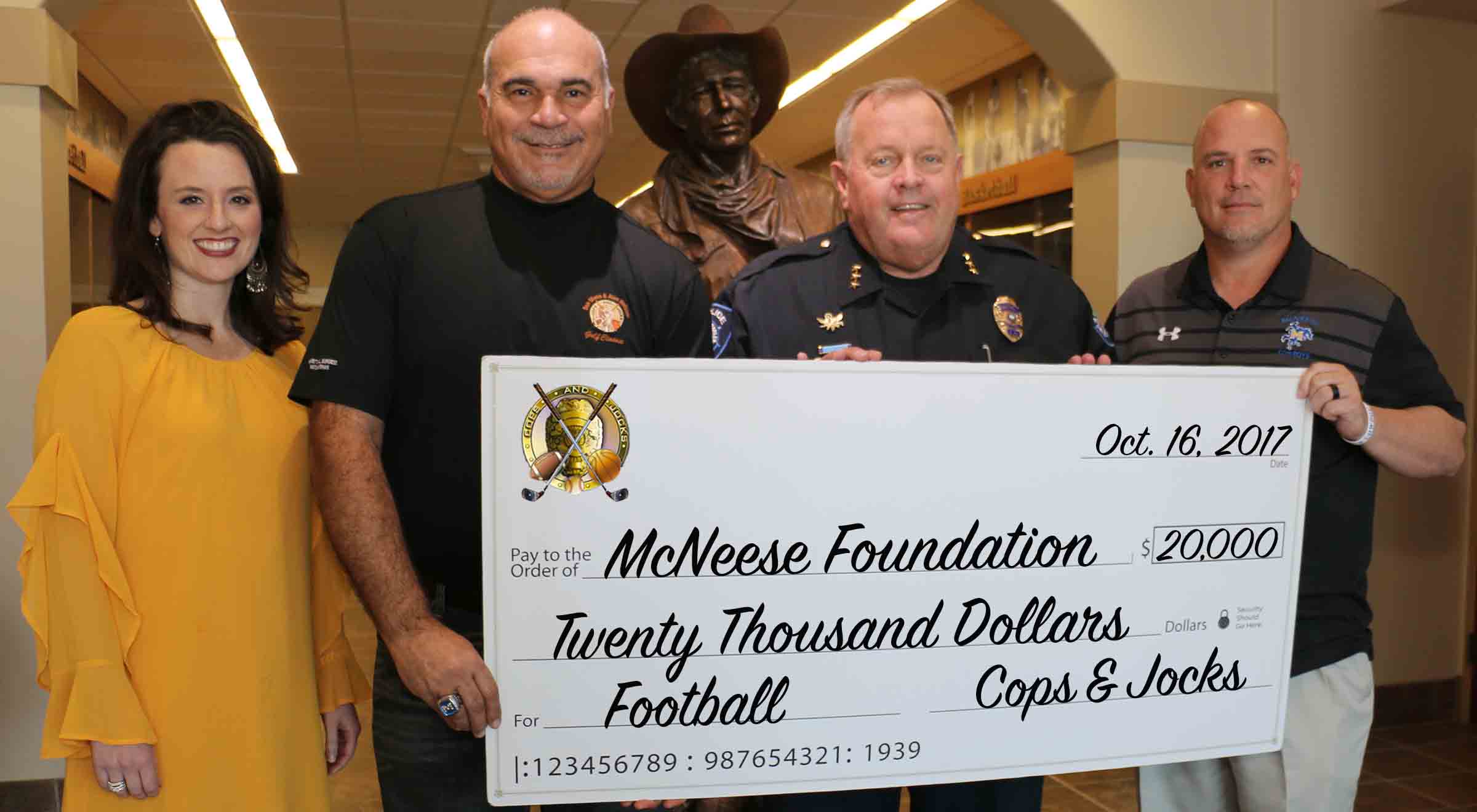 Cops&Jocks.10.16.17.crop Alan Heisser and Don Dixon of Cops and Jocks present a check to Jennifer Leger and Lance Guidry of McNeese.