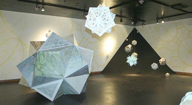 white paper sculptures similar to snowflakes by Rebecca Kreisler