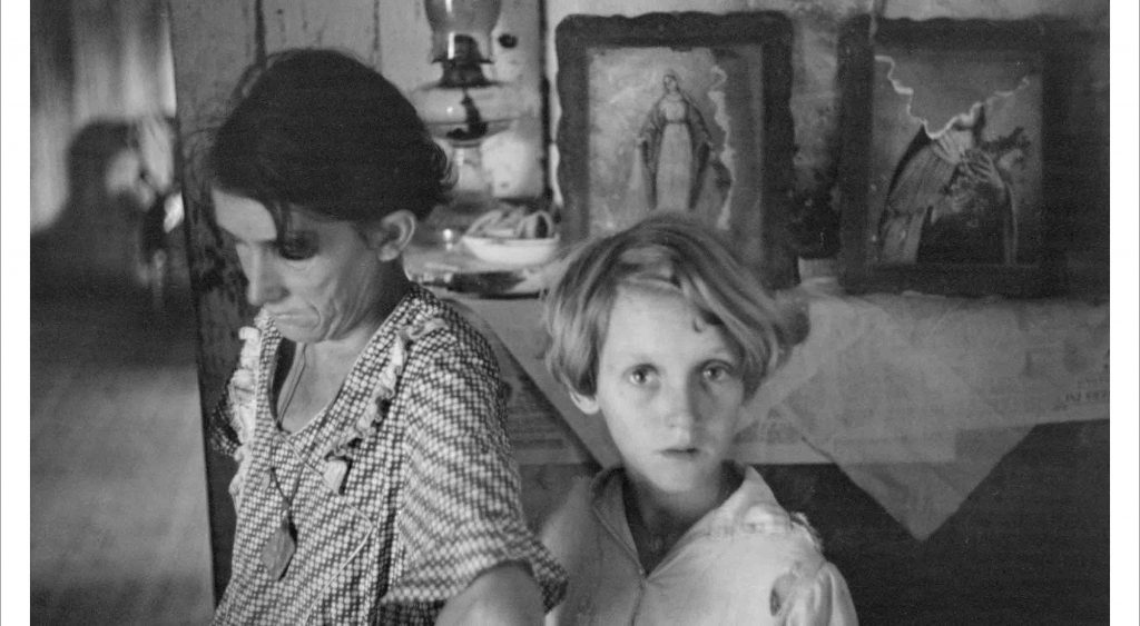 A woman and a young boy at home during the depression era.