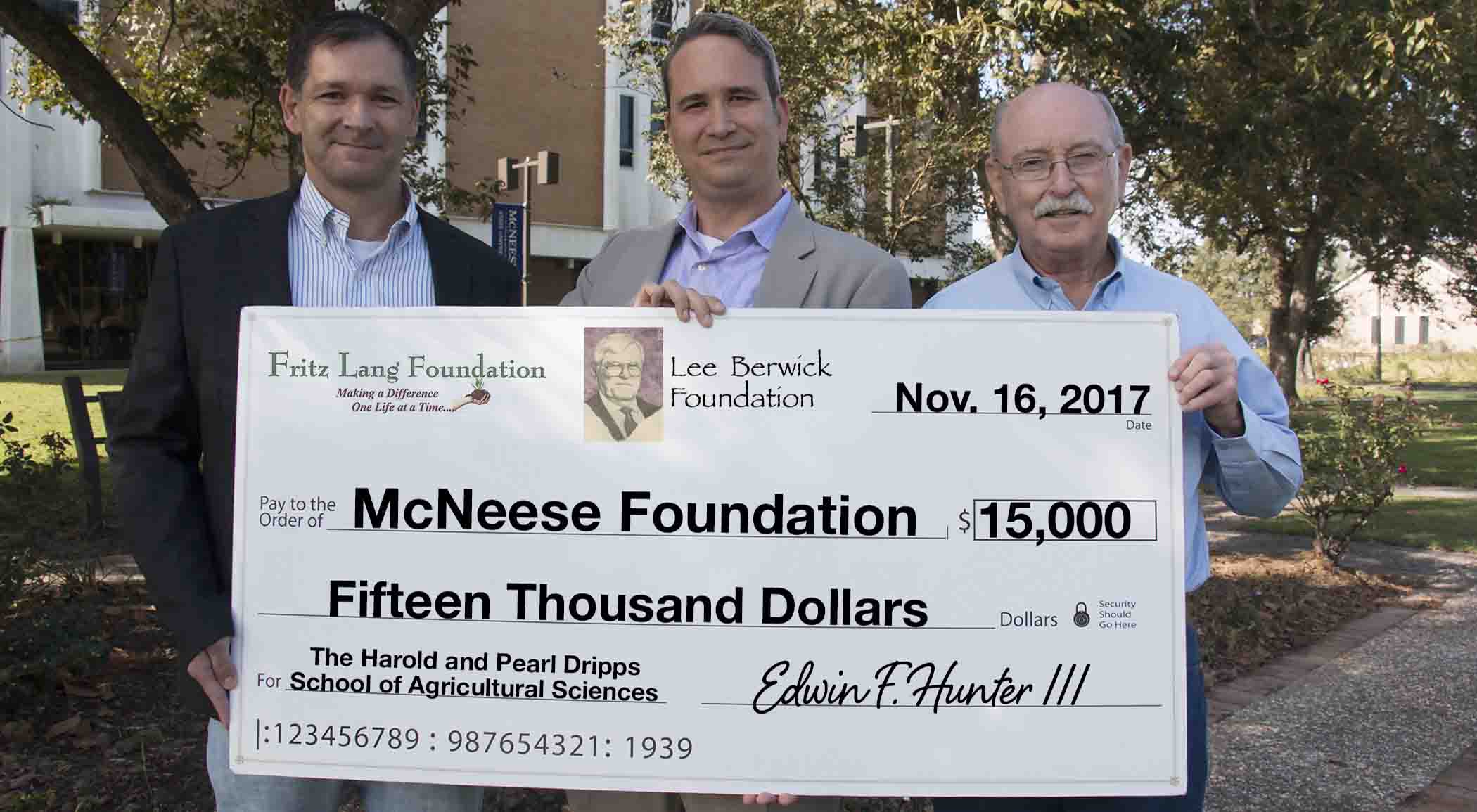 Dr. Chip LeMieux and Dwight Bertrand of McNeese accept a check from Edwin F. Hunter III of The Fritz Lang and Lee Berwick Foundations.