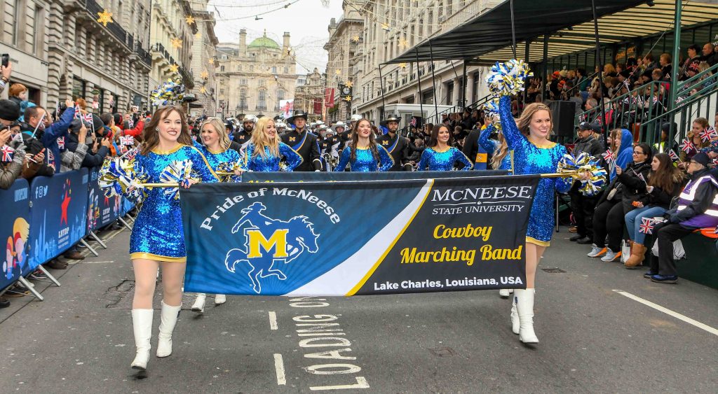 The McNeese Band and Cowgirl Kickers walk the streets of London in the parade.