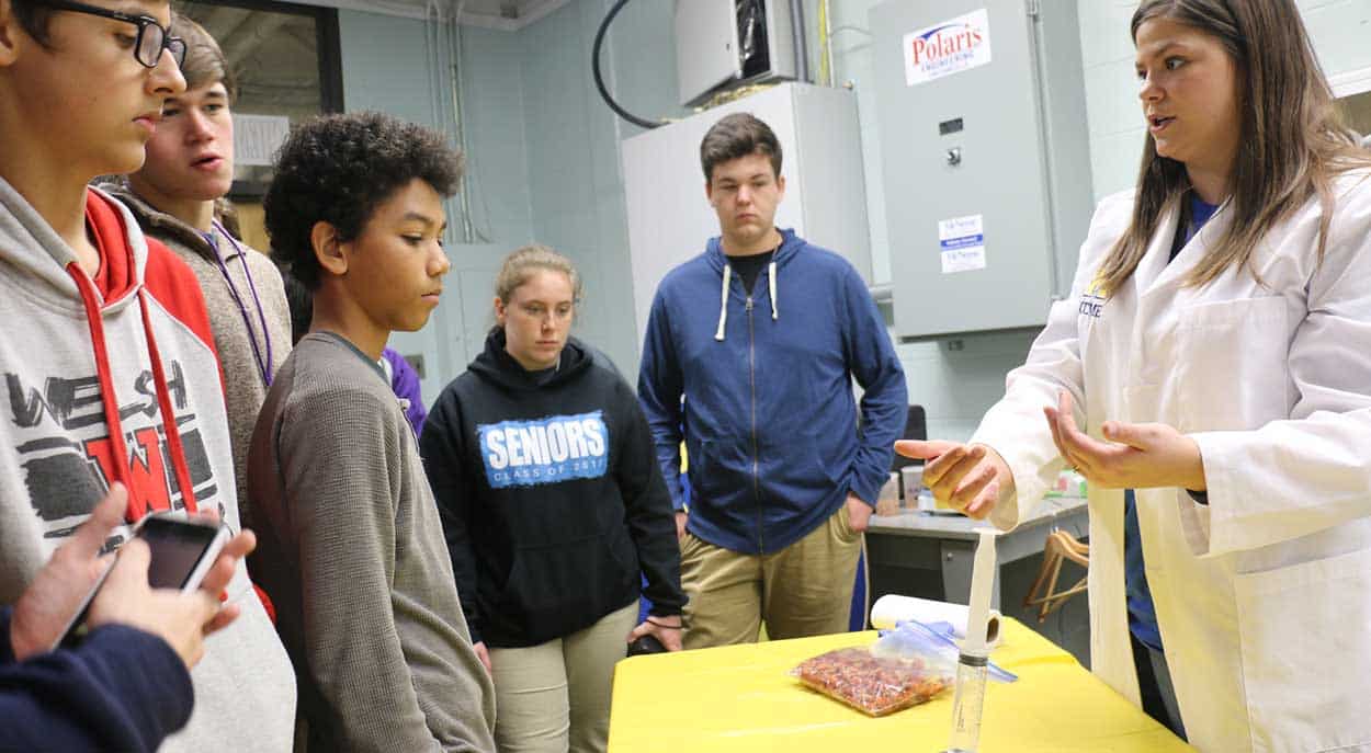 Visitors watch a demonstration by a McNeese student.