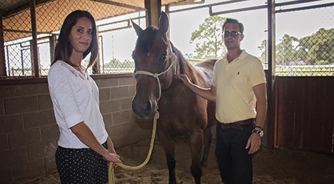 Sari Bosnyak and Dr. Edward Ferguson wit a horse