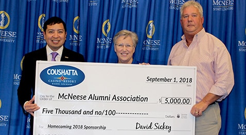 David Sickey and Greg Raynor of Coushatta present a check to Joyce Patterson of McNeese Alumni Association