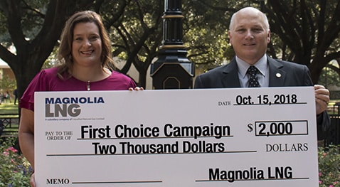 Tammy Truax of Magnolia LNG presents a check to McNeese President Dr. Daryl V. Burckel