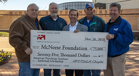 Butch Ferdinandsen, center, president-elect for the McNeese Foundation Board of Directors, accepts the donation from SWLA Chapter of API board members, from left, A.J. Vincent, James Nugent, Pat Hay and Todd Hine.