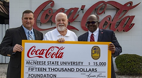 Blaine Royer, on-premise manager for Lake Charles Coca-Cola, Richard H. Reid, vice president for university advancement and executive vice president of the foundation, and Ken Francis, sales center manager for Lake Charles Coca-Cola.