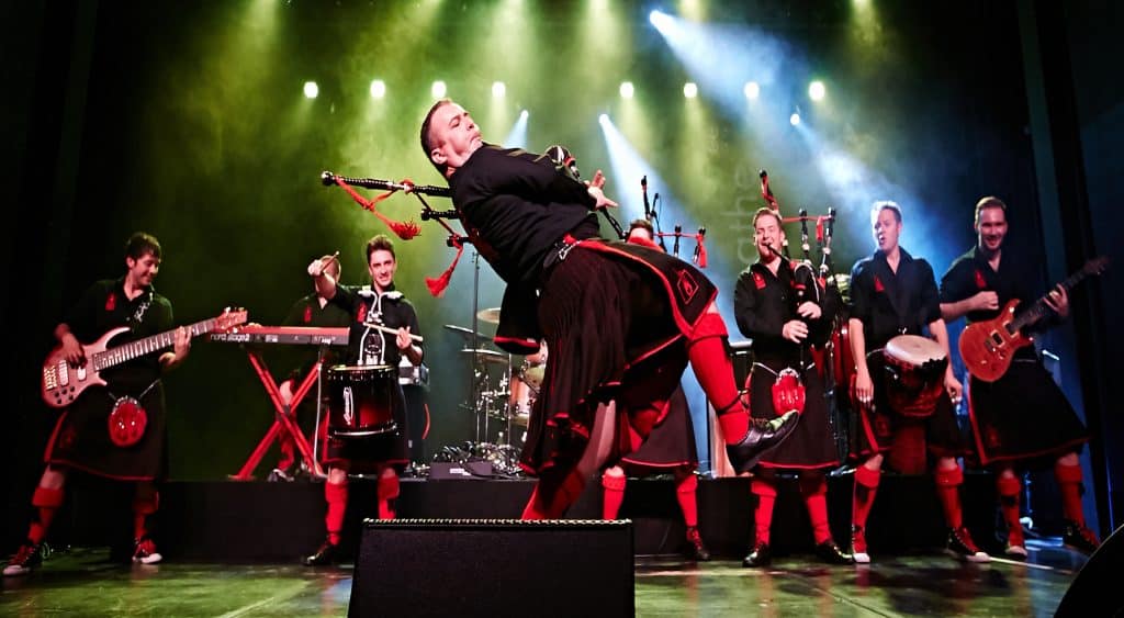 Red Hot Chilli Pipers perform with bagpipes on stage