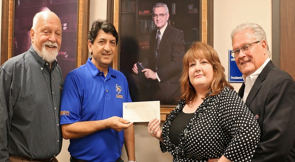 Richard H. Reid, vice president for university advancement and executive vice president of the foundation, Dr. Matthew Aghili, associate dean of the McNeese College of Engineering and Computer Science, and Karen and Ken Chamberlain. Karen’s grandfather is the late Dr. Thomas S. Leary, McNeese’s third president whose portrait is in the background.