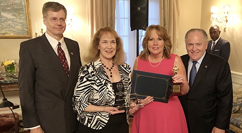 U.S. Small Business Administration Louisiana District Director Mike Ricks, along with Louisiana Economic Development Secretary Don Pierson, presents McNeese LSBDC Director Donna Little and Senior Business Consultant Susan Thibodeaux with the Region VI SBDC Excellence and Innovation Center award.