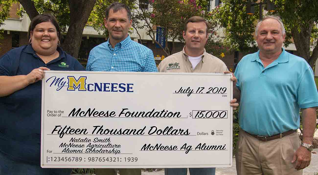 Dr. Chip LeMieux, second from left, dean of the College of Agricultural Sciences, accepts the donation from Agriculture Alumni Chapter executive officers, from left, Jennifer Compton, Jon Streete and Wayne McVicker. McNeese Photo