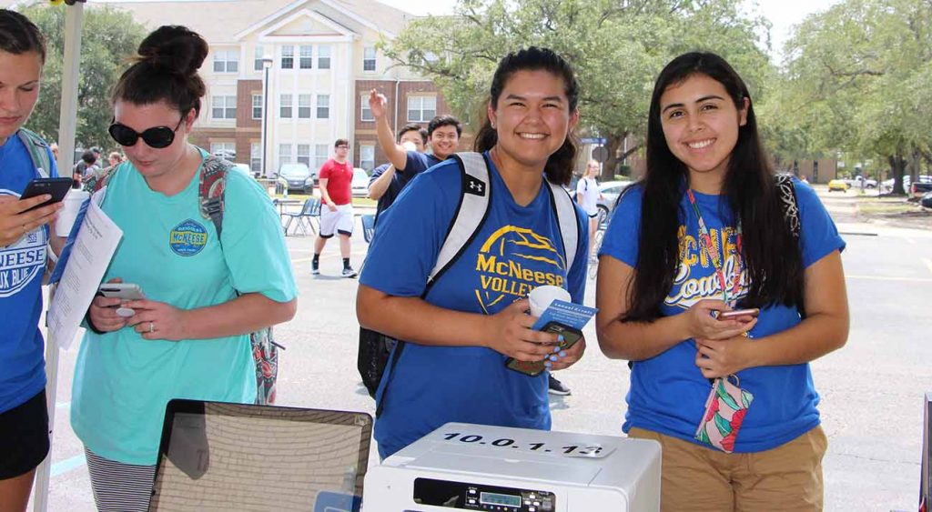 Two McNeese students smile for the camera while enjoying Howdy Rowdy Welcome Back events.