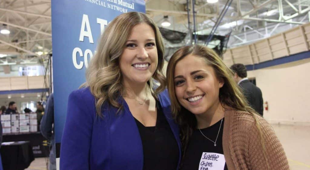 A company representative stands with a McNeese student at Career Fair.