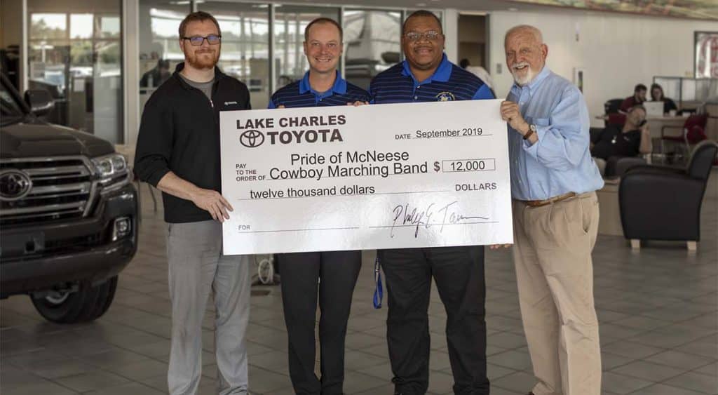 Corey Tarver, general manager of Lake Charles Toyota, Dr. Jay Sconyers, director of McNeese Bands, Dr. Jack Eaddy, assistant director of McNeese Bands, and Richard H. Reid, vice president for university advancement and executive vice president of the McNeese Foundation. McNeese Photo