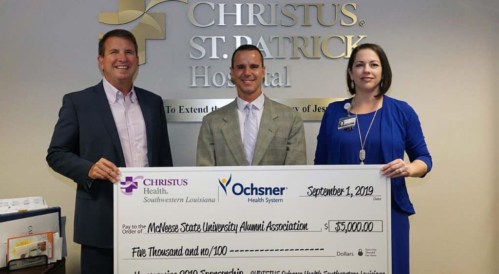 On hand for the donation are, from left, Kevin Holland, CEO, Brad Guillory, McNeese Alumni Association president, and Heather Hidalgo, director of marketing and communications.