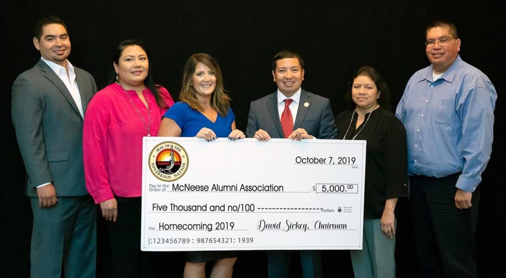 Stephanie Clark, third from left, assistant director for alumni affairs, receives the donation, from left, Johnathan Cernek, Coushatta Tribe of Louisiana councilman, Crystal Williams, councilwoman, David Sickey, chairman, Loretta Williams, secretary and treasurer, and Kevin Sickey, vice chairman.