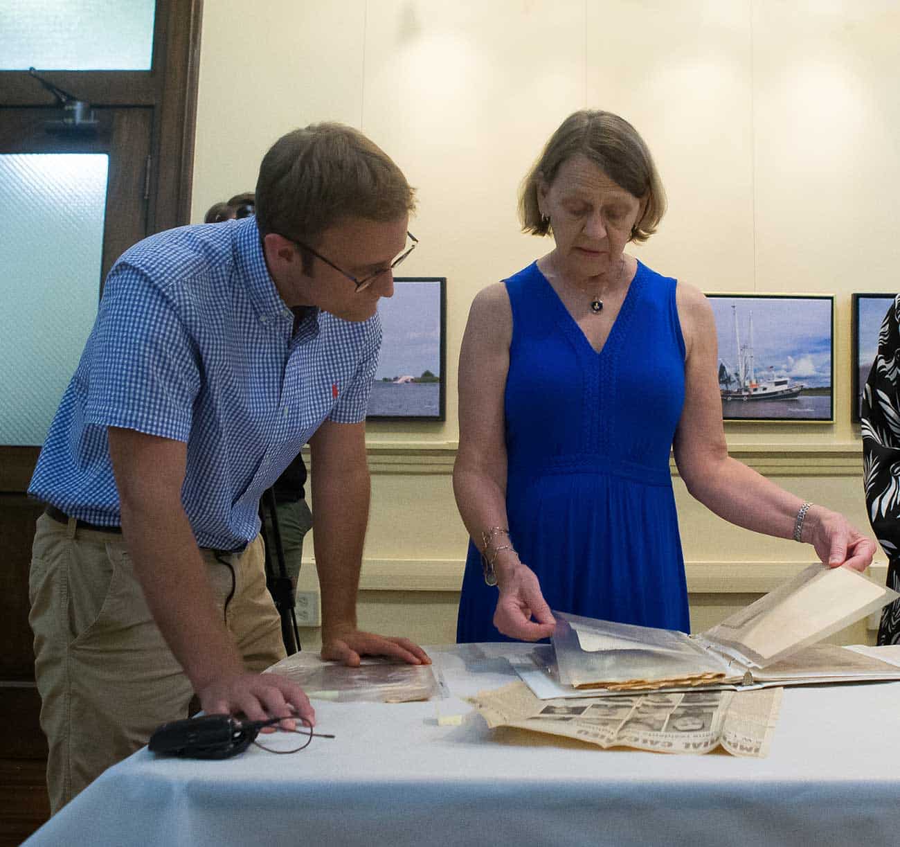 Intern Grant Leonards assists a local resident with her documents