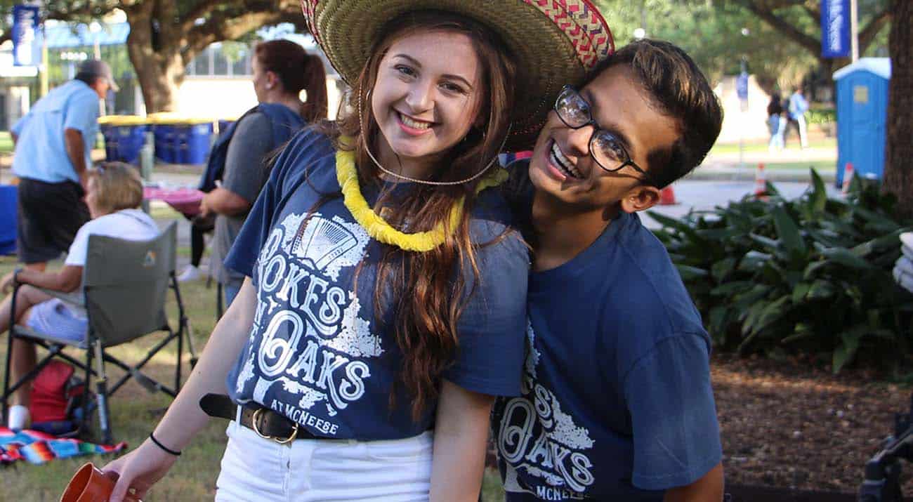 Two students smile for the camera during Pokes in the Oaks