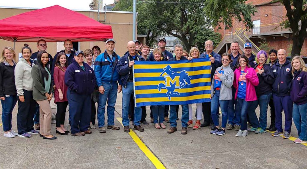 McNeese alumni currently working at CITGO proudly display the McNeese flag to be on display for the next year in front of the refinery.