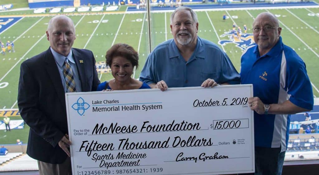 On hand for the presentation are, from left, Dr. Daryl Burckel, McNeese president, Kim Graham, Larry Graham, Lake Charles Memorial Hospital CEO, and Dr. Mitchell Adrian, McNeese provost and vice president for academic affairs and enrollment management.