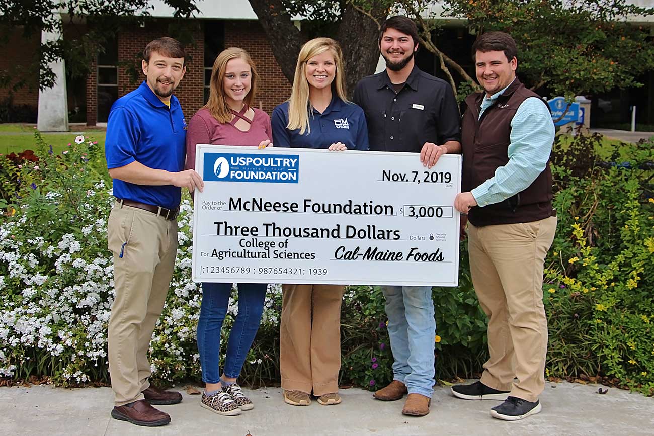 Photo of McNeese faculty and US Poultry representatives with check