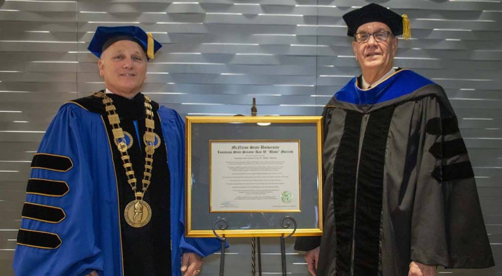 McNeese State University President Dr. Daryl V. Burckel, left, presented Louisiana State Sen. Dan W. “Blade” Morrish with an honorary Doctor of Humane Letters degree during McNeese’s fall commencement ceremony Saturday, Dec. 14, at the McNeese Health and Human Performance Education Complex.