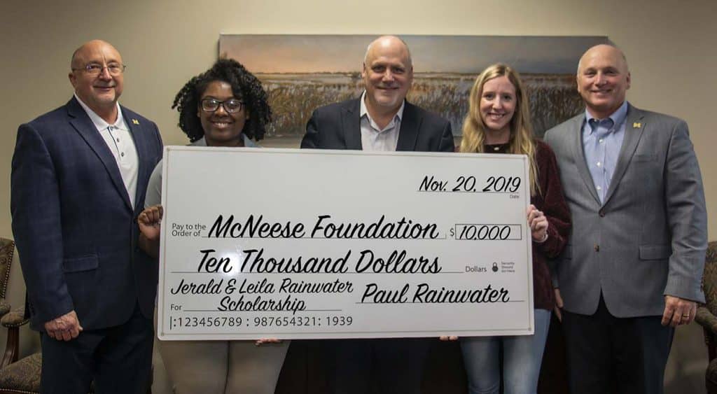 On hand for the presentation are, from left, Essence Means, biological science major, Rainwater, and Ashlyn Wesley, finance major. Not pictured are Sylvia Stagg, sociology major, and Robert Henry, psychology major.