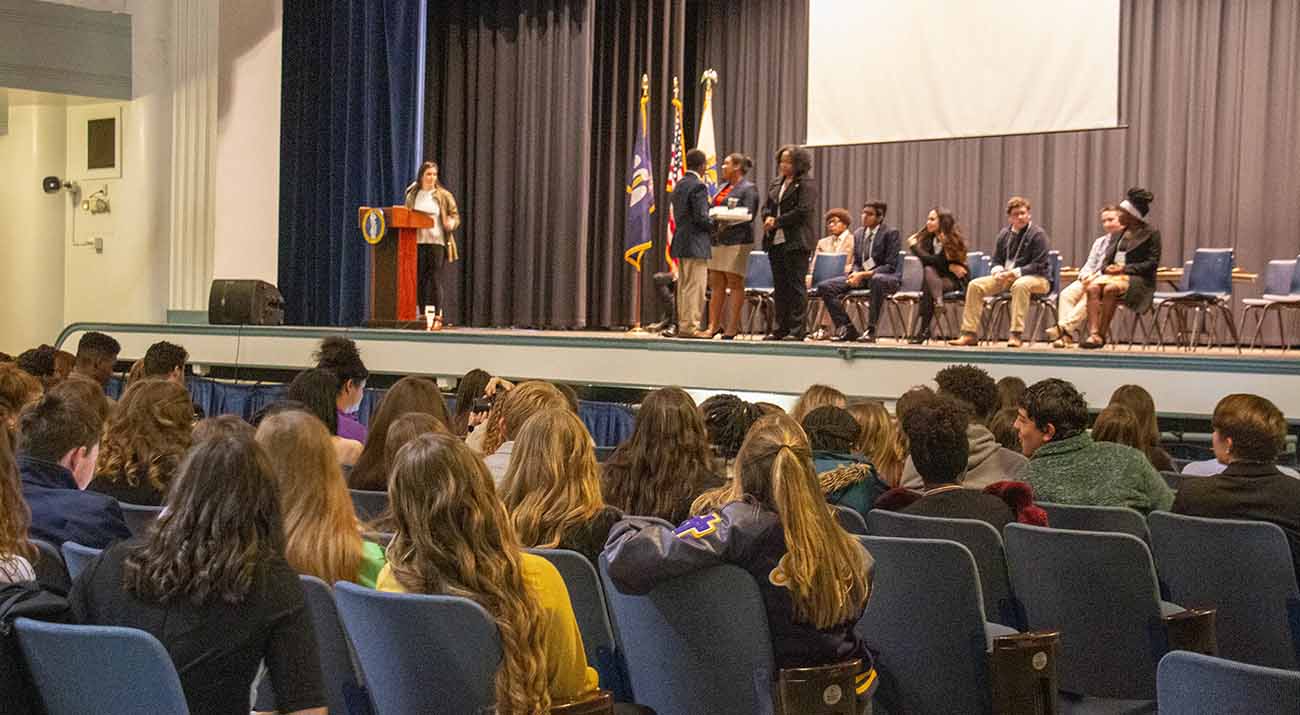 FBLA students stand on stage as they answer a series of Jeopardy style questions in front of their peers.