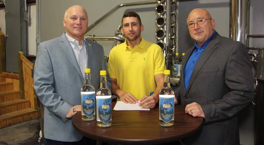 McNeese State University has signed a marketing agreement with Yellowfin Distillery in Sulphur to receive a portion of the sale of a new beverage - Single Estate Vodka “Geaux Pokes” Edition – that is currently available in area retail stores. On hand for the signing are, from left, Dr. Daryl Burckel, McNeese president, Jamison Trouth, McNeese graduate and president and CEO of Yellowfin Distillery, and Dr. Mitchell Adrian, McNeese provost and vice president for academic affairs and enrollment management.