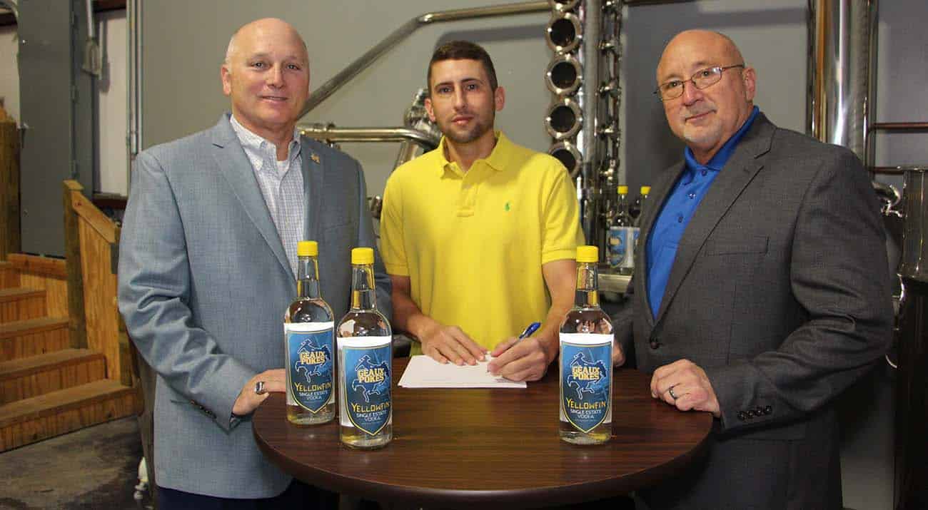 McNeese State University has signed a marketing agreement with Yellowfin Distillery in Sulphur to receive a portion of the sale of a new beverage - Single Estate Vodka “Geaux Pokes” Edition – that is currently available in area retail stores. On hand for the signing are, from left, Dr. Daryl Burckel, McNeese president, Jamison Trouth, McNeese graduate and president and CEO of Yellowfin Distillery, and Dr. Mitchell Adrian, McNeese provost and vice president for academic affairs and enrollment management.