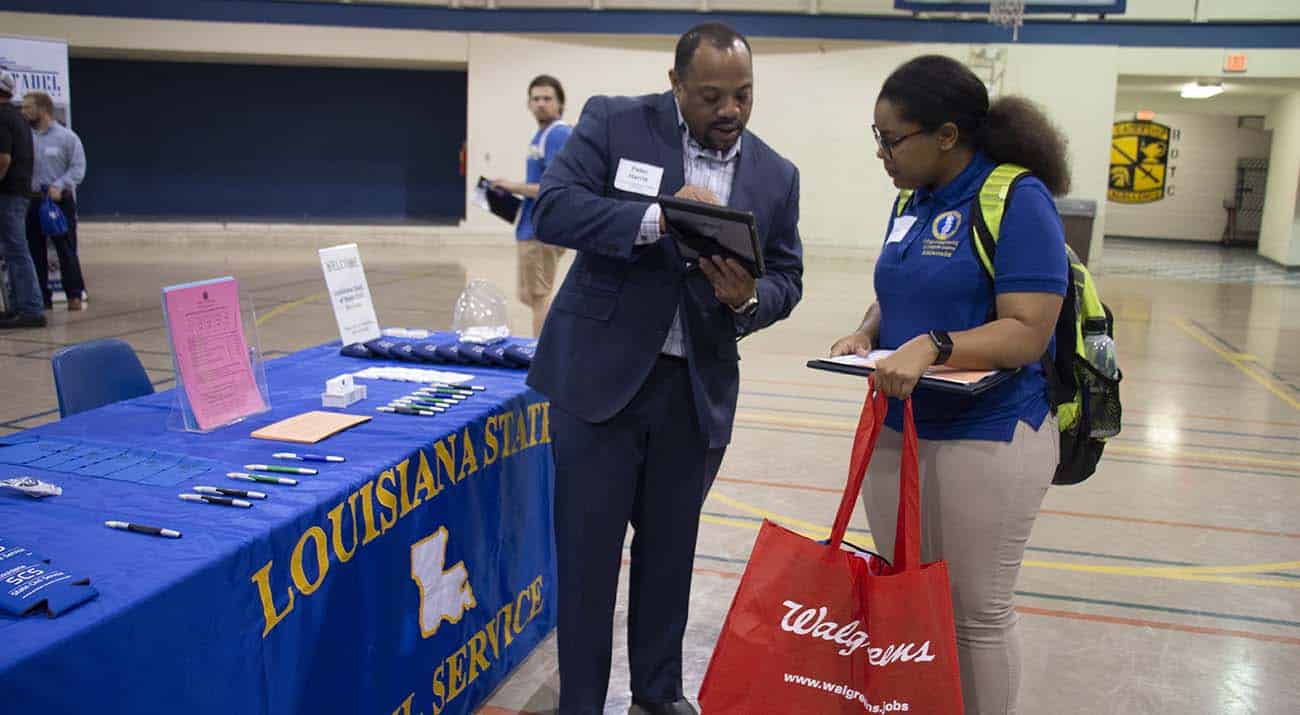 A recruiter goes over job descriptions with a McNeese students